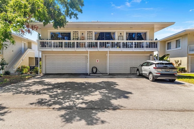 1813 Bough Ave Unit B, Clearwater, FL 33760 - view of front facade with driveway, an attached garage, and stucco siding