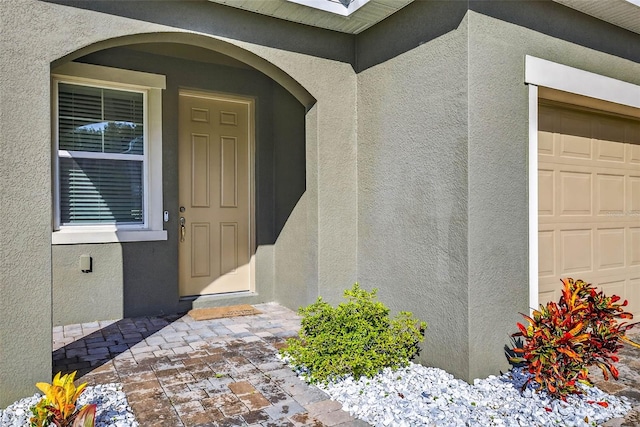 33854 Floating Heart Ct, Wesley Chapel, FL 33545 - entrance to property featuring stucco siding and a garage