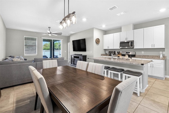 33854 Floating Heart Ct, Wesley Chapel, FL 33545 - dining area featuring light tile patterned floors, ceiling fan, and recessed lighting