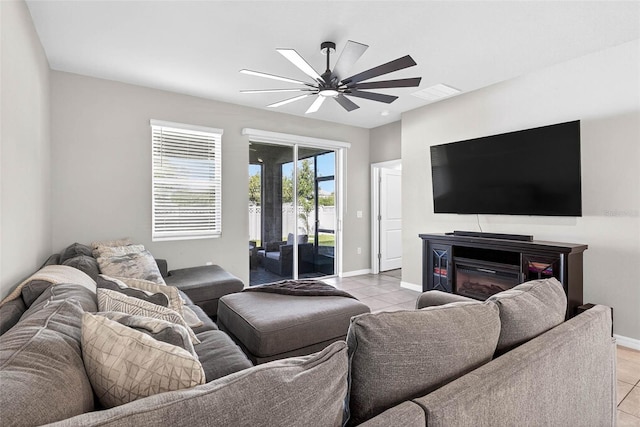 33854 Floating Heart Ct, Wesley Chapel, FL 33545 - living area with ceiling fan, light tile patterned floors, and a glass covered fireplace