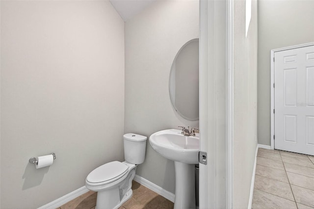 33854 Floating Heart Ct, Wesley Chapel, FL 33545 - half bath with toilet and tile patterned floors