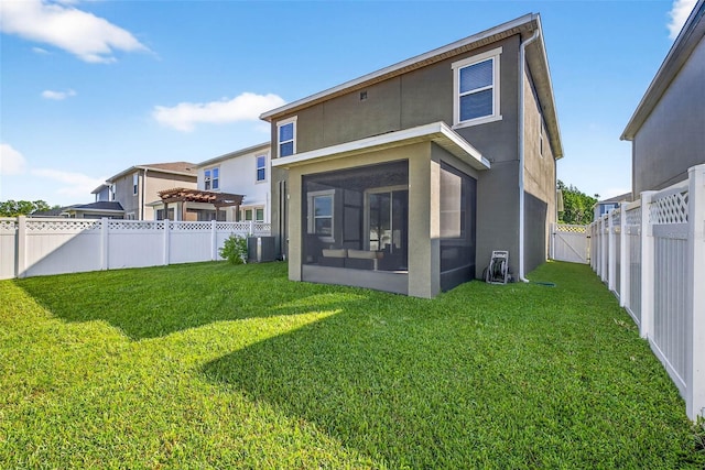 33854 Floating Heart Ct, Wesley Chapel, FL 33545 - rear view of house with a sunroom, a fenced backyard, stucco siding, and a gate
