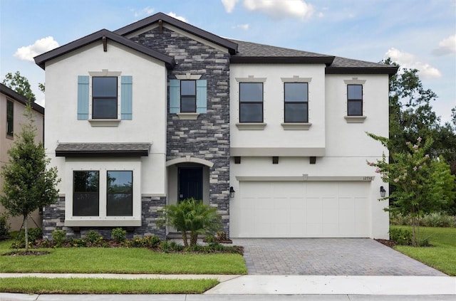 12758 Oak Hill Way, Parrish, FL 34219 - view of front of property featuring stone siding, stucco siding, driveway, an attached garage, and a front yard