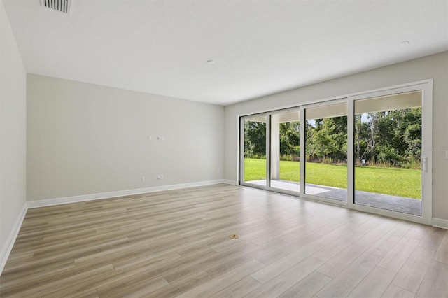 12758 Oak Hill Way, Parrish, FL 34219 - unfurnished room with baseboards and light wood-type flooring