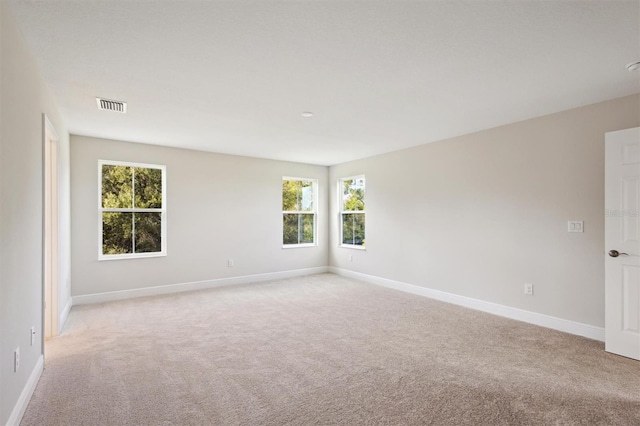 12758 Oak Hill Way, Parrish, FL 34219 - empty room with light carpet and plenty of natural light