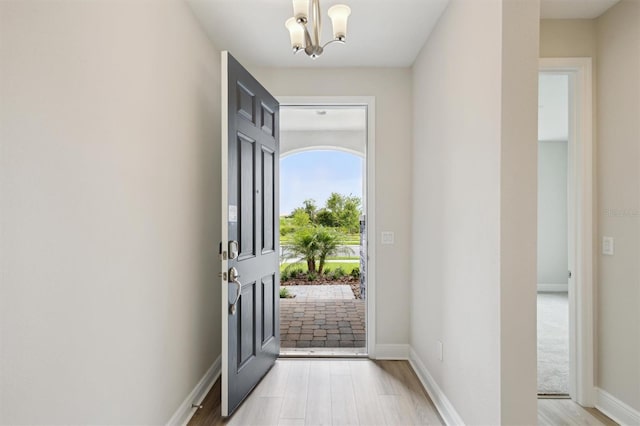 12758 Oak Hill Way, Parrish, FL 34219 - foyer featuring a chandelier and light wood-style floors