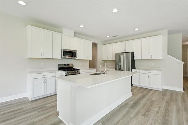 12758 Oak Hill Way, Parrish, FL 34219 - kitchen featuring stainless steel appliances, light wood-style floors, white cabinets, and recessed lighting
