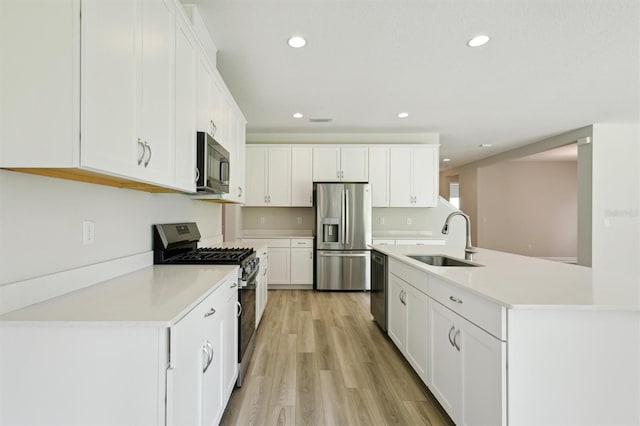 12758 Oak Hill Way, Parrish, FL 34219 - kitchen with appliances with stainless steel finishes, light countertops, white cabinetry, light wood-type flooring, and recessed lighting
