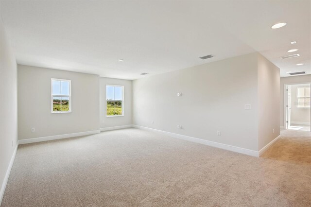 12758 Oak Hill Way, Parrish, FL 34219 - unfurnished room with light carpet and plenty of natural light