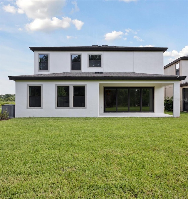 12758 Oak Hill Way, Parrish, FL 34219 - back of house featuring stucco siding and a lawn