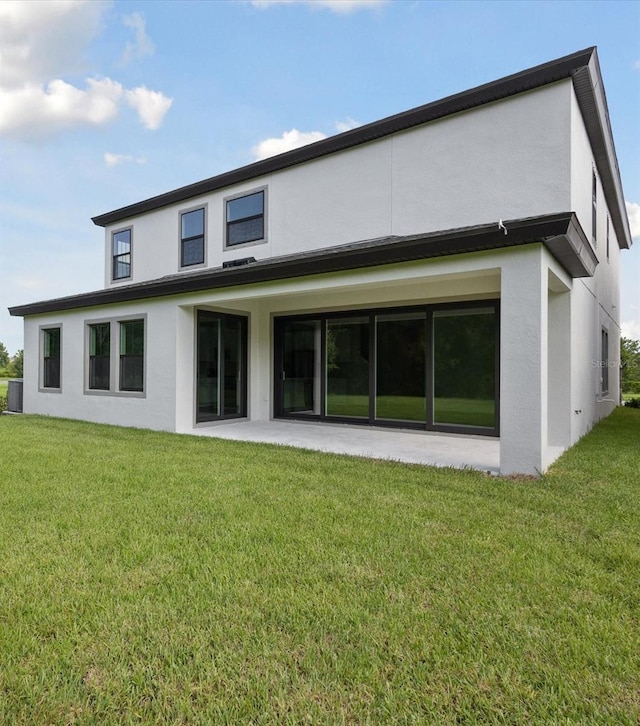 12758 Oak Hill Way, Parrish, FL 34219 - rear view of property featuring stucco siding and a lawn