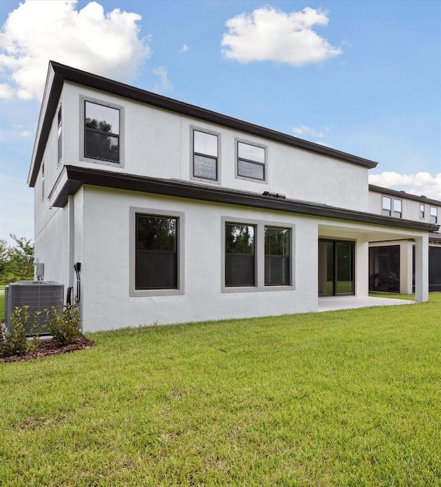 12758 Oak Hill Way, Parrish, FL 34219 - rear view of house featuring stucco siding and a yard