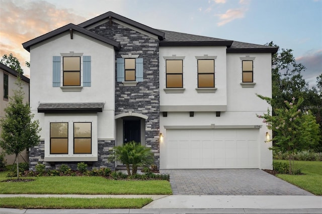 12758 Oak Hill Way, Parrish, FL 34219 - view of front of property featuring stone siding, stucco siding, a garage, and driveway