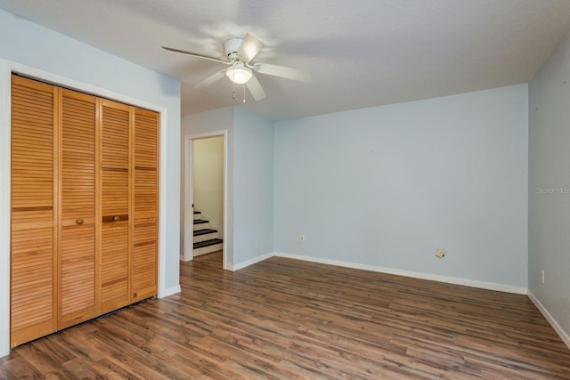 9660 Tara Cay Ct Unit 38, Seminole, FL 33776 - unfurnished bedroom featuring wood finished floors, a closet, and a ceiling fan