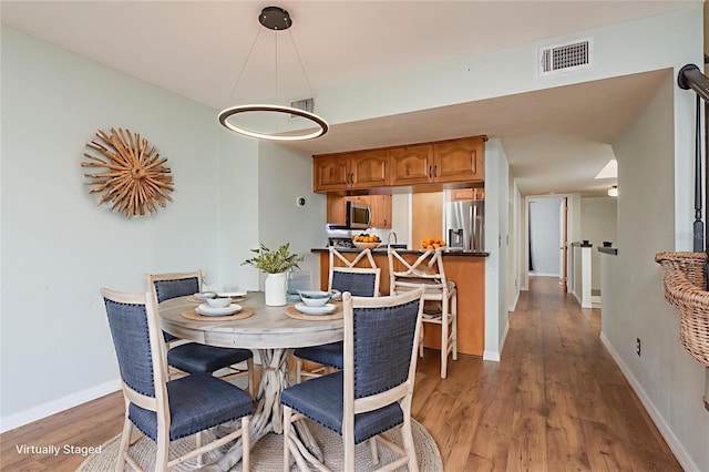 9660 Tara Cay Ct Unit 38, Seminole, FL 33776 - dining area with light wood-style flooring
