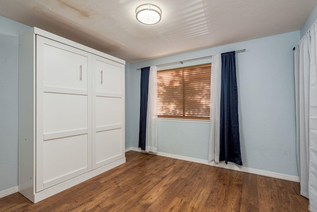 9660 Tara Cay Ct Unit 38, Seminole, FL 33776 - unfurnished bedroom featuring a closet and wood finished floors