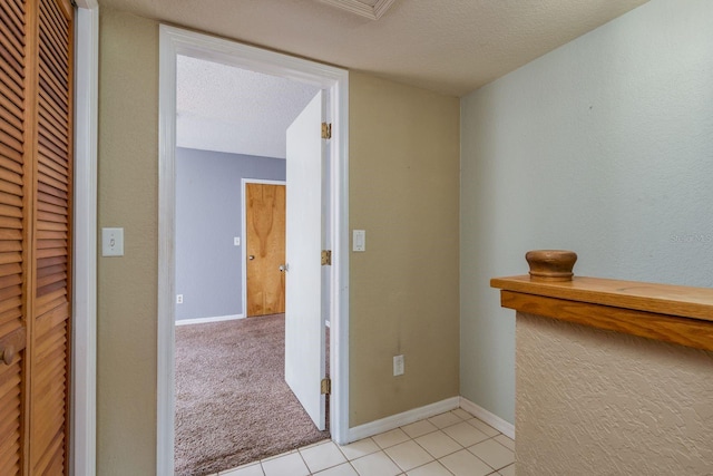 9660 Tara Cay Ct Unit 38, Seminole, FL 33776 - corridor with light tile patterned floors and a textured ceiling