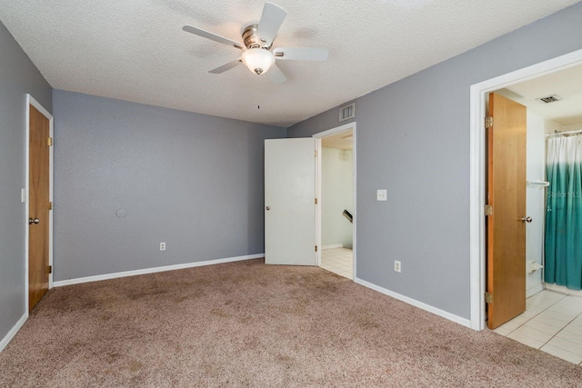 9660 Tara Cay Ct Unit 38, Seminole, FL 33776 - unfurnished bedroom with carpet flooring, a textured ceiling, ensuite bath, and ceiling fan