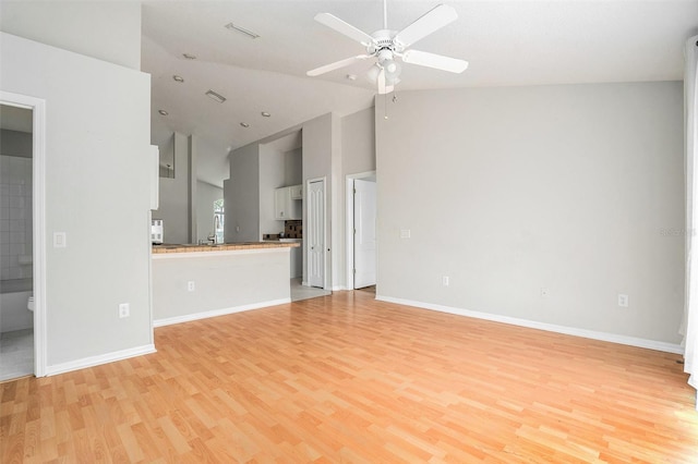 10039 Creek Bluff Dr, Riverview, FL 33578 - unfurnished living room with high vaulted ceiling, light wood finished floors, and a ceiling fan