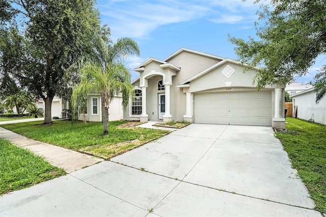 10039 Creek Bluff Dr, Riverview, FL 33578 - view of front of home featuring driveway, stucco siding, a garage, and a front yard