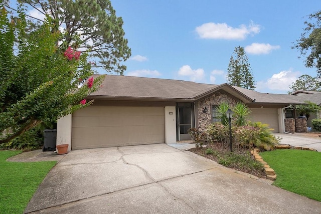 3902 Shoreside Cir, Tampa, FL 33624 - view of front facade featuring an attached garage, driveway, stone siding, and a front yard
