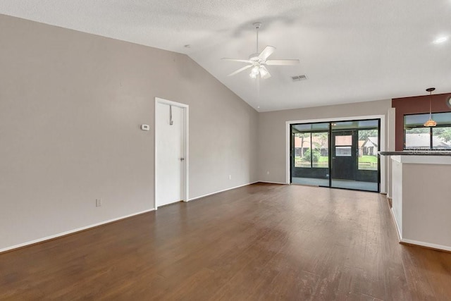 3902 Shoreside Cir, Tampa, FL 33624 - empty room with a ceiling fan, wood finished floors, vaulted ceiling, and healthy amount of natural light
