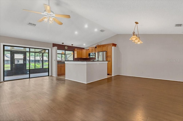 3902 Shoreside Cir, Tampa, FL 33624 - kitchen featuring lofted ceiling, open floor plan, stainless steel appliances, wood finished floors, and ceiling fan