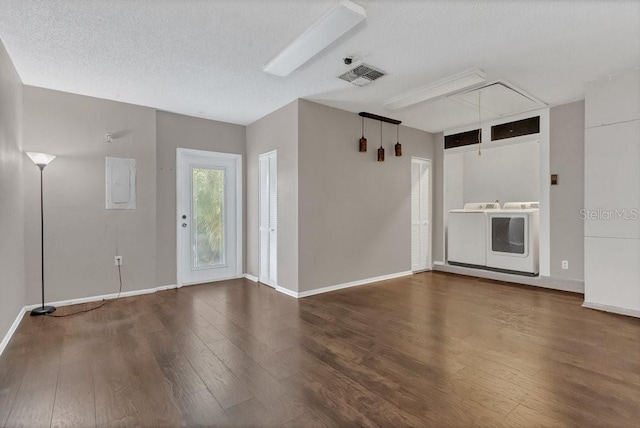 3902 Shoreside Cir, Tampa, FL 33624 - unfurnished living room featuring attic access, wood finished floors, washing machine and clothes dryer, and a textured ceiling