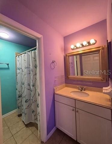 5110 Corvette Dr, Tampa, FL 33624 - bathroom featuring vanity, tile patterned floors, and a shower with shower curtain
