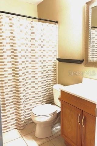 5110 Corvette Dr, Tampa, FL 33624 - bathroom featuring vanity, tile patterned flooring, and curtained shower