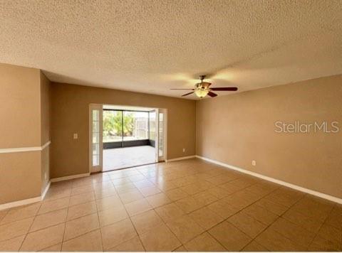 5110 Corvette Dr, Tampa, FL 33624 - empty room featuring a ceiling fan and a textured ceiling