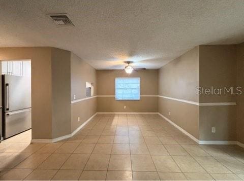 5110 Corvette Dr, Tampa, FL 33624 - empty room featuring ceiling fan, light tile patterned floors, and a textured ceiling