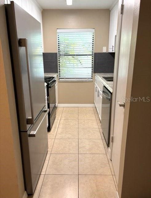 5110 Corvette Dr, Tampa, FL 33624 - kitchen featuring appliances with stainless steel finishes, white cabinetry, decorative backsplash, and light countertops