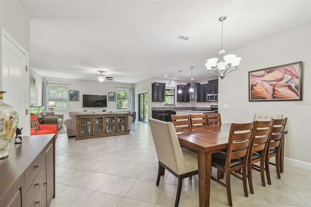 28568 Tranquil Lake Cir, Wesley Chapel, FL 33543 - dining area featuring light tile patterned floors, a chandelier, and a ceiling fan