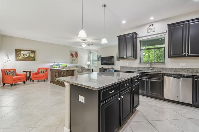 28568 Tranquil Lake Cir, Wesley Chapel, FL 33543 - kitchen with stainless steel dishwasher, open floor plan, light tile patterned flooring, dark cabinetry, and a ceiling fan