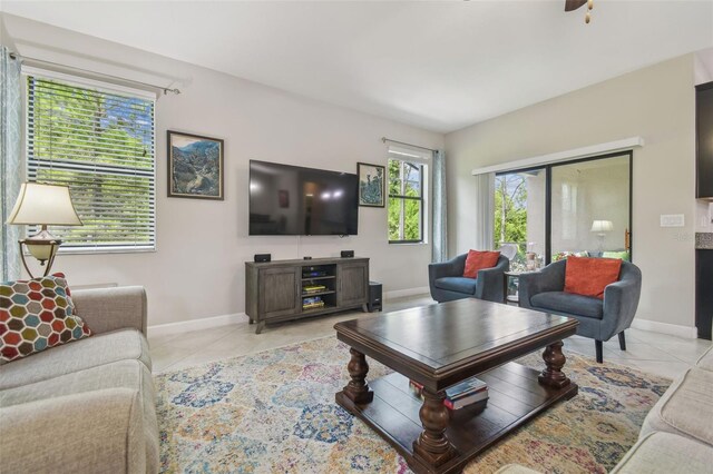 28568 Tranquil Lake Cir, Wesley Chapel, FL 33543 - living area with light tile patterned floors and a ceiling fan