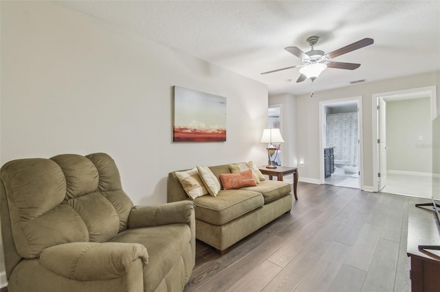 28568 Tranquil Lake Cir, Wesley Chapel, FL 33543 - living area featuring ceiling fan and wood finished floors