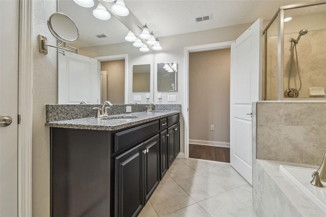 28568 Tranquil Lake Cir, Wesley Chapel, FL 33543 - full bath featuring double vanity, a relaxing tiled tub, a tile shower, tile patterned floors, and a chandelier