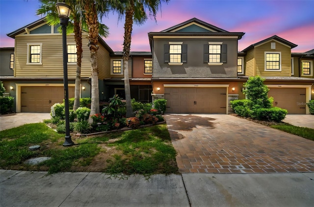 28568 Tranquil Lake Cir, Wesley Chapel, FL 33543 - view of front of home featuring stucco siding, a garage, and decorative driveway