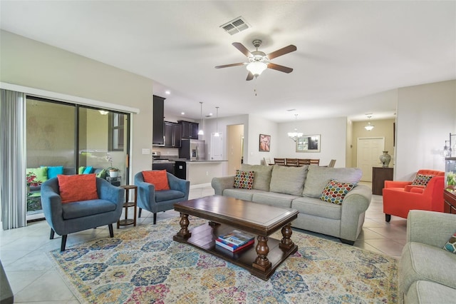 28568 Tranquil Lake Cir, Wesley Chapel, FL 33543 - living area featuring light tile patterned flooring, a ceiling fan, and a chandelier