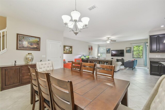 28568 Tranquil Lake Cir, Wesley Chapel, FL 33543 - dining room featuring a chandelier, light tile patterned floors, and ceiling fan