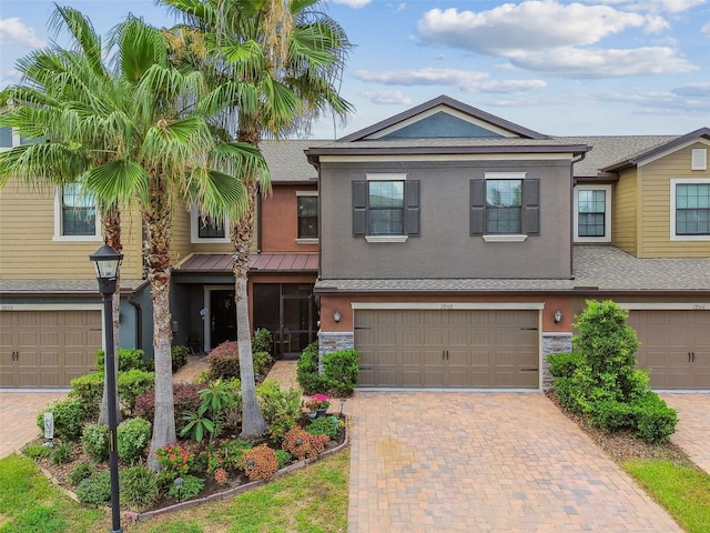 28568 Tranquil Lake Cir, Wesley Chapel, FL 33543 - multi unit property with stucco siding, decorative driveway, a garage, and stone siding