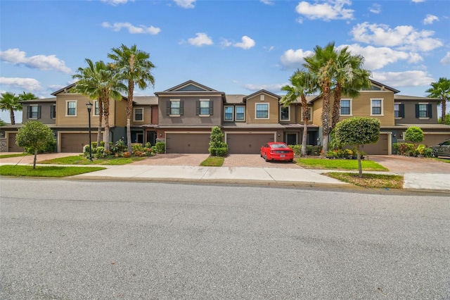 28568 Tranquil Lake Cir, Wesley Chapel, FL 33543 - multi unit property with an attached garage, stucco siding, driveway, and a residential view