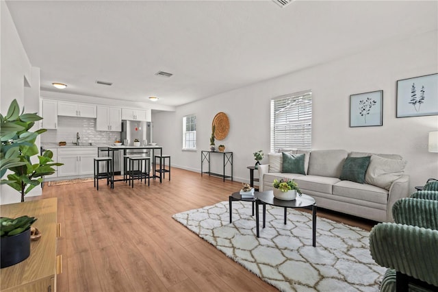 1743 Fulton Ave, Clearwater, FL 33755 - living room featuring light wood-type flooring and baseboards