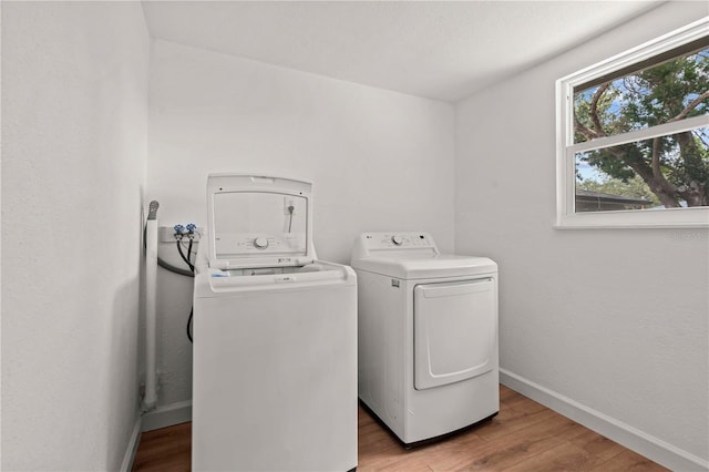1743 Fulton Ave, Clearwater, FL 33755 - laundry room with washer and dryer and light wood-style flooring