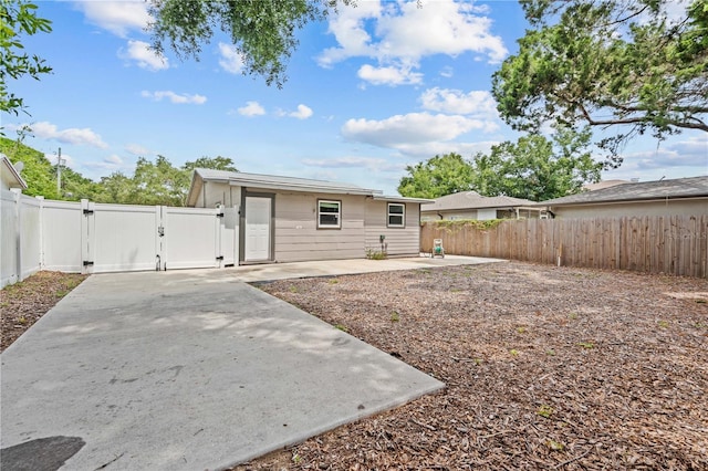 1743 Fulton Ave, Clearwater, FL 33755 - back of property featuring a gate, a patio, and a fenced backyard