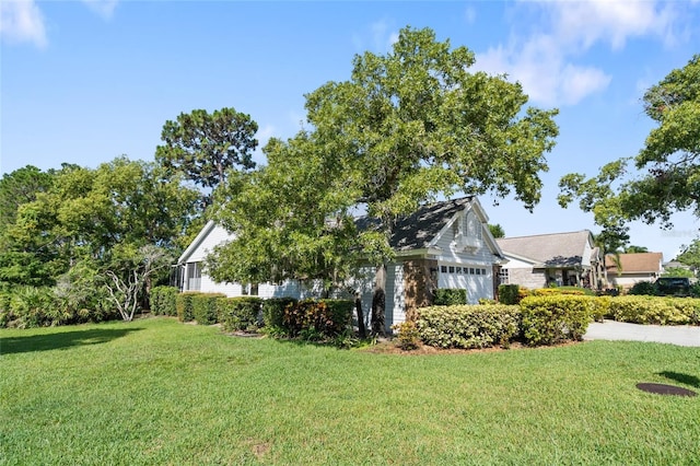 2182 Trevor Rd, Palm Harbor, FL 34683 - view of side of property featuring a garage and a lawn
