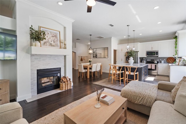2182 Trevor Rd, Palm Harbor, FL 34683 - living room with crown molding, wood finished floors, a fireplace, ceiling fan, and recessed lighting