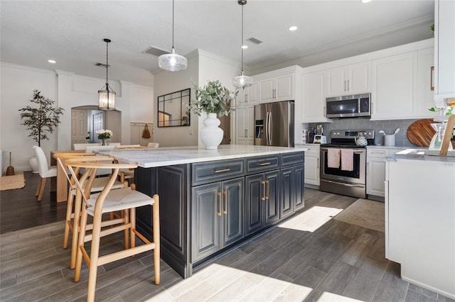 2182 Trevor Rd, Palm Harbor, FL 34683 - kitchen with stainless steel appliances, white cabinetry, light countertops, recessed lighting, and backsplash