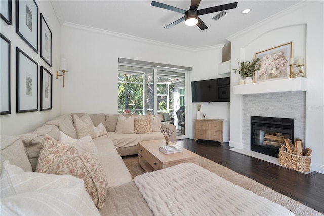 2182 Trevor Rd, Palm Harbor, FL 34683 - living room with crown molding, dark wood-style flooring, a ceiling fan, a fireplace, and recessed lighting